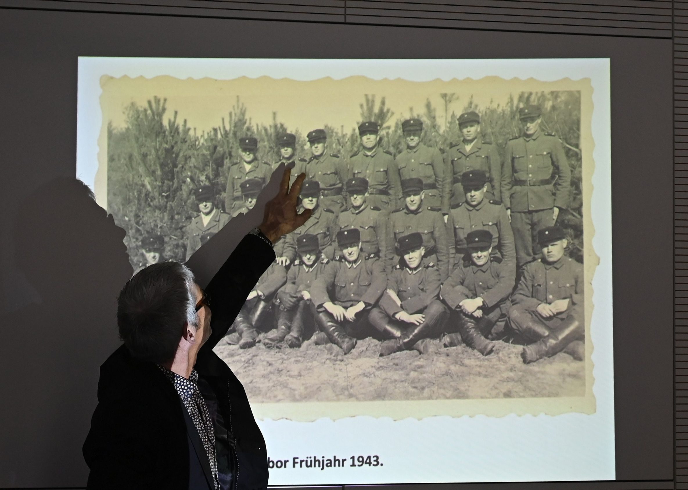 A staff member of the Topography of Terror archive points at a historical photograph allegedly showing John Demjanjuk during a press conference on newly discovered photos from Sobibor Nazi death camp on January 28, 2020 in Berlin. - Berlin-based Topography of Terror archive presented on January 28, 2020 newly discovered photos from the former Nazi concentration camp Sobibor. (Photo by Tobias SCHWARZ / AFP) / RESTRICTED TO EDITORIAL USE / TO ILLUSTRATE THE EVENT AS SPECIFIED IN THE CAPTION